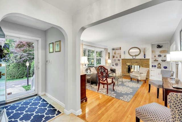 7 Woods Rd, Locust Valley, NY 11560 - entryway with plenty of natural light, baseboards, arched walkways, and a multi sided fireplace