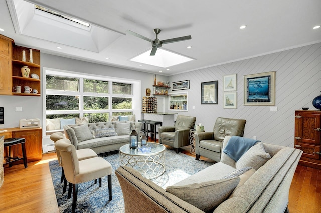 7 Woods Rd, Locust Valley, NY 11560 - living room with a skylight, a ceiling fan, light wood-type flooring, ornamental molding, and a baseboard radiator