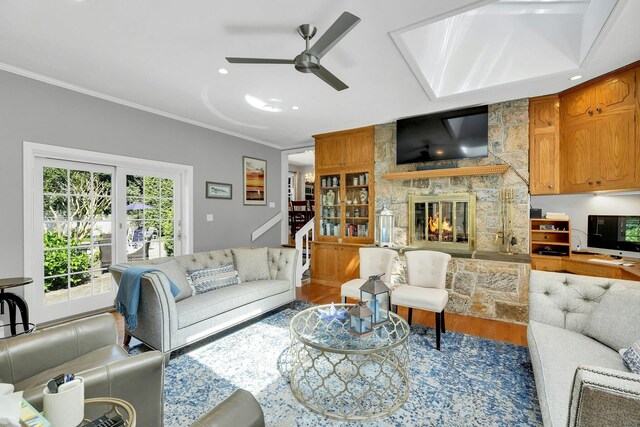 7 Woods Rd, Locust Valley, NY 11560 - living area with a ceiling fan, a fireplace, ornamental molding, wood finished floors, and stairway