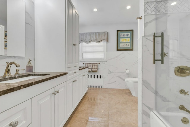 7 Woods Rd, Locust Valley, NY 11560 - full bath with radiator, tile walls, vanity, toilet, and shower / bathtub combination