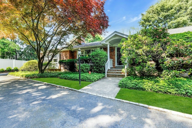 7 Woods Rd, Locust Valley, NY 11560 - view of front facade featuring brick siding