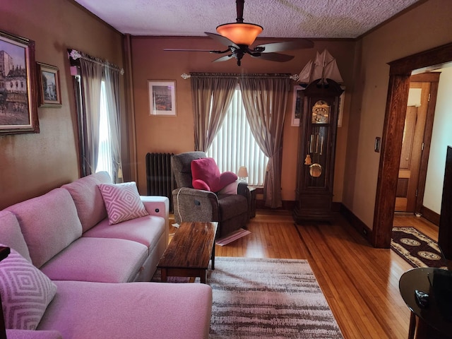 30 Royce Ave, Middletown, NY 10940 - living room featuring ceiling fan, wood finished floors, radiator, a textured ceiling, and baseboards