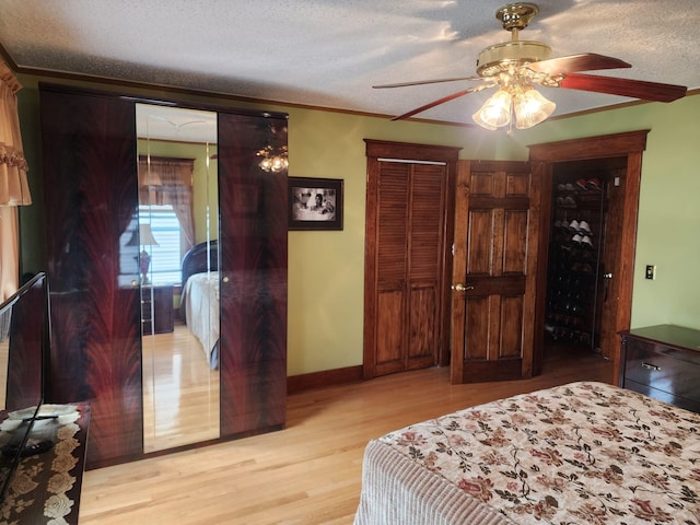 30 Royce Ave, Middletown, NY 10940 - bedroom with light wood-style floors, a textured ceiling, crown molding, baseboards, and a ceiling fan