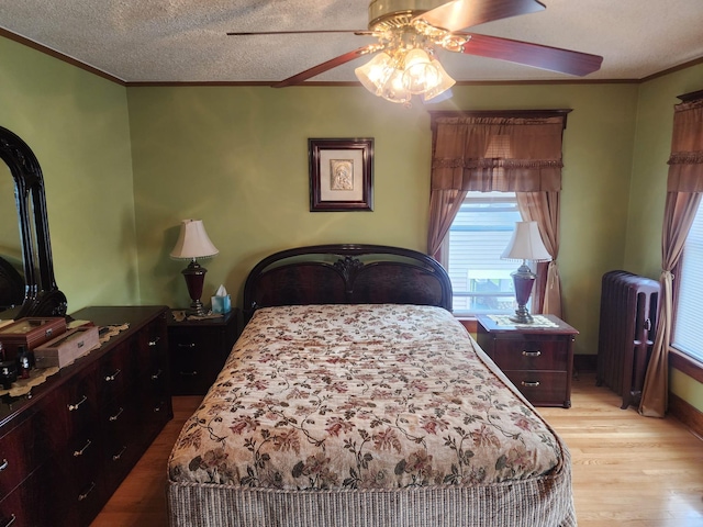 30 Royce Ave, Middletown, NY 10940 - bedroom featuring radiator, crown molding, wood finished floors, a ceiling fan, and a textured ceiling