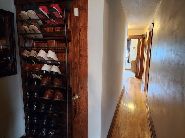 30 Royce Ave, Middletown, NY 10940 - corridor with hardwood / wood-style floors, a textured ceiling, and baseboards