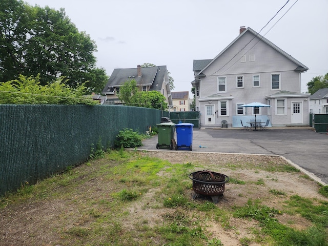 30 Royce Ave, Middletown, NY 10940 - fenced backyard with a fire pit and a patio area
