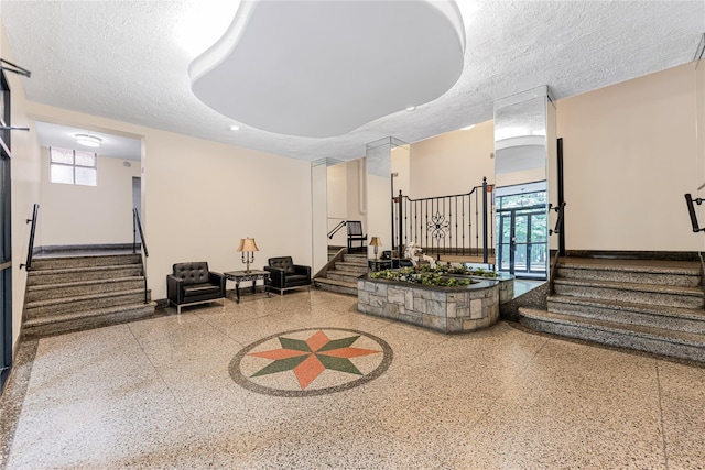 277 Bronx River Rd Unit 2A, Yonkers, NY 10704 - common area with stairway and a textured ceiling