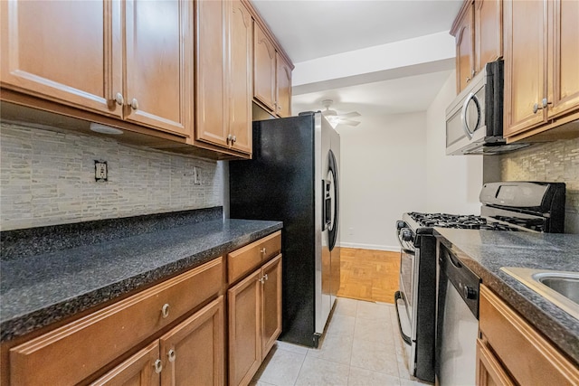 277 Bronx River Rd Unit 2A, Yonkers, NY 10704 - kitchen with stainless steel appliances, ceiling fan, tasteful backsplash, and brown cabinetry