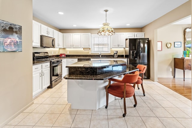 8 Lakeview Ct, Riverhead, NY 11901 - kitchen featuring appliances with stainless steel finishes, a breakfast bar area, white cabinets, and recessed lighting