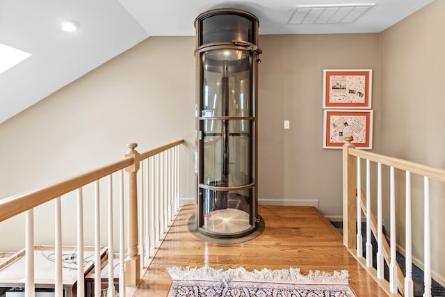 8 Lakeview Ct, Riverhead, NY 11901 - hall with an upstairs landing, a skylight, wood finished floors, and lofted ceiling