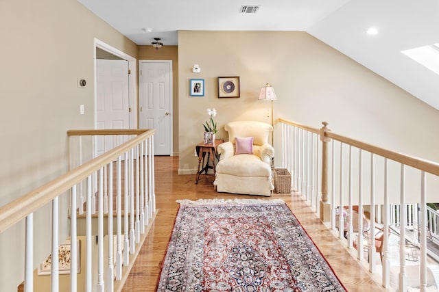 8 Lakeview Ct, Riverhead, NY 11901 - living area featuring light wood-style flooring, vaulted ceiling, and a skylight