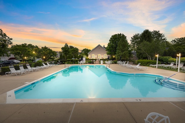 8 Lakeview Ct, Riverhead, NY 11901 - pool at dusk featuring a patio area and a community pool
