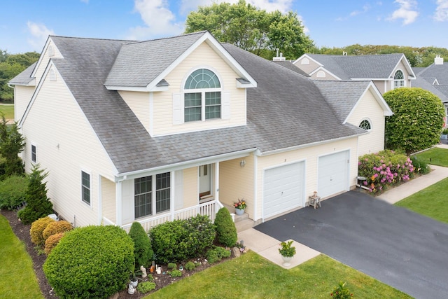 8 Lakeview Ct, Riverhead, NY 11901 - view of front of property with a porch, an attached garage, driveway, a shingled roof, and a front lawn
