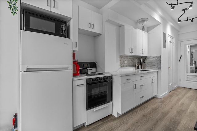 310 Riverside Dr Unit 1509, New York Manhattan, NY 10025 - kitchen featuring freestanding refrigerator, range, light wood-type flooring, light countertops, and black microwave