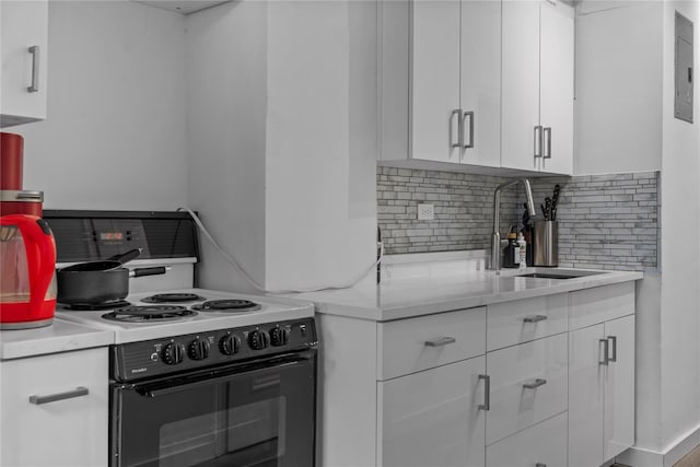 310 Riverside Dr Unit 1509, New York Manhattan, NY 10025 - kitchen featuring electric range, tasteful backsplash, white cabinets, and electric panel