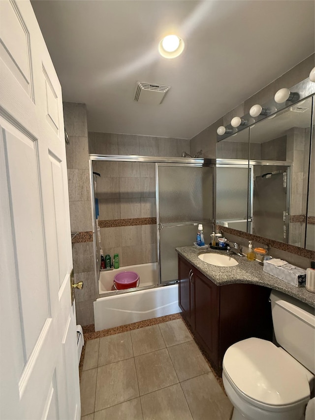 41-05 College Point Blvd Unit 3Fl, Flushing, NY 11355 - full bath with tile patterned flooring, toilet, vanity, and shower / bath combination with glass door