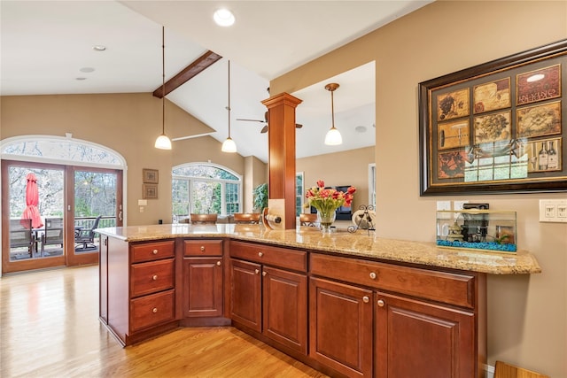 45 Henry St, Merrick, NY 11566 - kitchen with light wood-type flooring, light stone counters, pendant lighting, and a peninsula