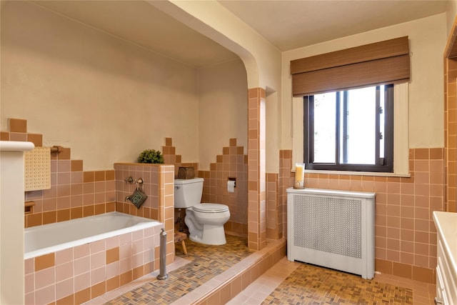 45 Henry St, Merrick, NY 11566 - bathroom featuring radiator heating unit, tile walls, toilet, a garden tub, and tile patterned floors