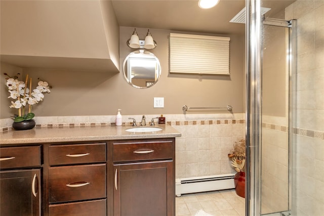 45 Henry St, Merrick, NY 11566 - bathroom featuring baseboard heating, a stall shower, vanity, tile walls, and tile patterned flooring