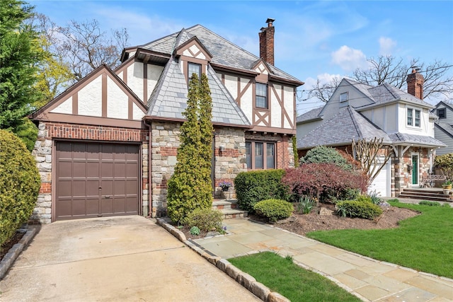 45 Henry St, Merrick, NY 11566 - english style home featuring stone siding, concrete driveway, a chimney, and a garage