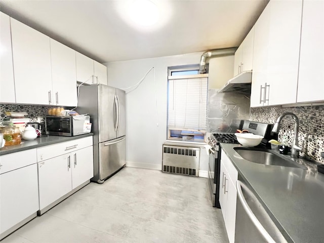 134-39 Blossom Ave Unit 1E, Flushing, NY 11354 - kitchen featuring radiator, appliances with stainless steel finishes, under cabinet range hood, a sink, and dark countertops