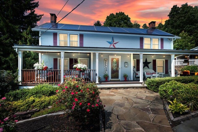 278 Gibson Hill Rd, Chester, NY 10918 - view of front of property with a chimney, a porch, and roof mounted solar panels