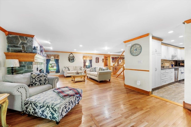 278 Gibson Hill Rd, Chester, NY 10918 - living room featuring a stone fireplace, light wood-type flooring, recessed lighting, stairway, and baseboards