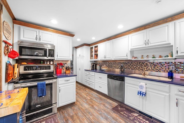 278 Gibson Hill Rd, Chester, NY 10918 - kitchen with appliances with stainless steel finishes, wood finished floors, dark countertops, tasteful backsplash, and white cabinets