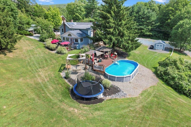 278 Gibson Hill Rd, Chester, NY 10918 - swimming pool featuring a trampoline, a gazebo, a lawn, an outdoor structure, and a wooded view
