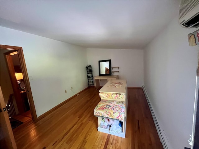 278 Gibson Hill Rd, Chester, NY 10918 - bedroom with wood finished floors, a wall unit AC, and baseboards