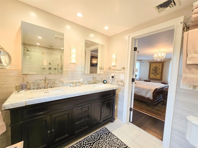 352 Mill Spring Rd, Manhasset, NY 11030 - full bathroom with tile patterned flooring, tile walls, a stall shower, connected bathroom, and double vanity