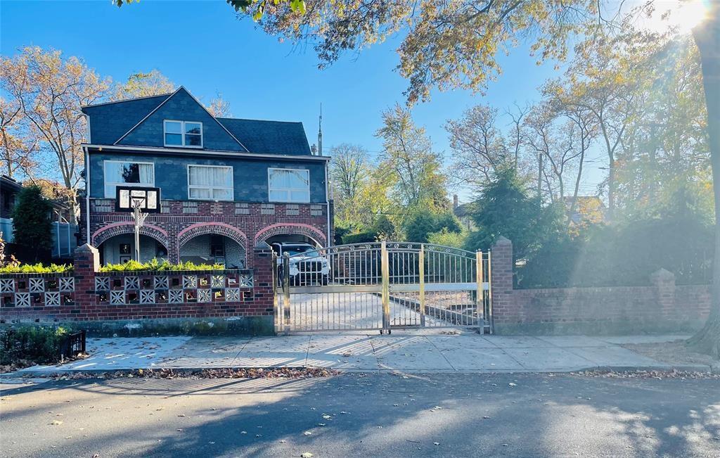 29-05 Murray St, Flushing, NY 11354 - view of front of property with a gate, concrete driveway, and brick siding