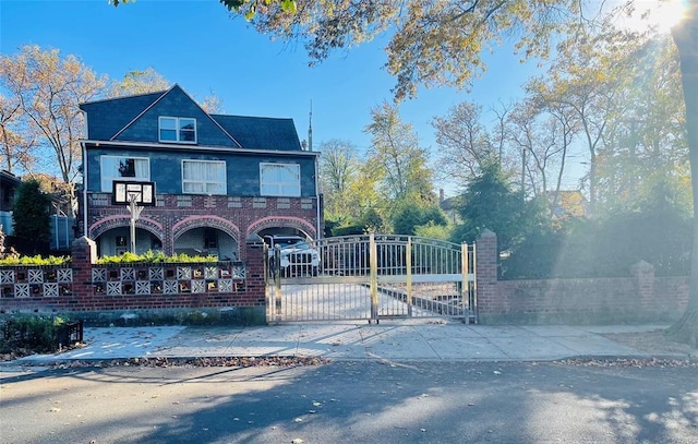 29-05 Murray St, Flushing, NY 11354 - view of front of property with a gate, concrete driveway, and brick siding