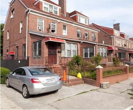 3317 87th St, Jackson Heights, NY 11372 - view of property with brick siding, a chimney, and cooling unit