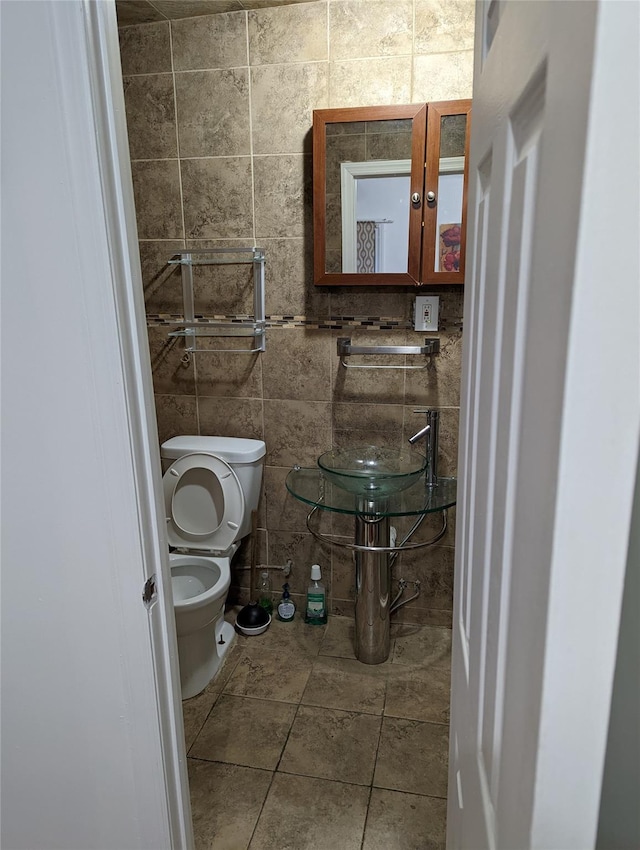 3317 87th St, Jackson Heights, NY 11372 - bathroom with toilet, tile walls, and tile patterned flooring