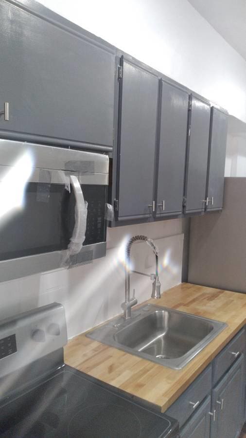 3317 87th St, Jackson Heights, NY 11372 - kitchen with wood counters, stainless steel appliances, a sink, and gray cabinets
