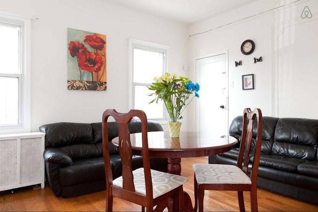 3317 87th St, Jackson Heights, NY 11372 - dining space featuring wood finished floors and radiator