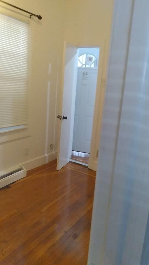 3317 87th St, Jackson Heights, NY 11372 - spare room featuring wood finished floors and baseboards