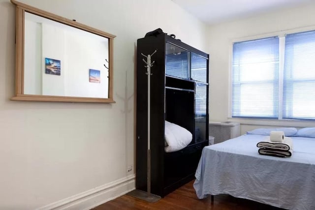3317 87th St, Jackson Heights, NY 11372 - bedroom featuring dark wood-style flooring and baseboards