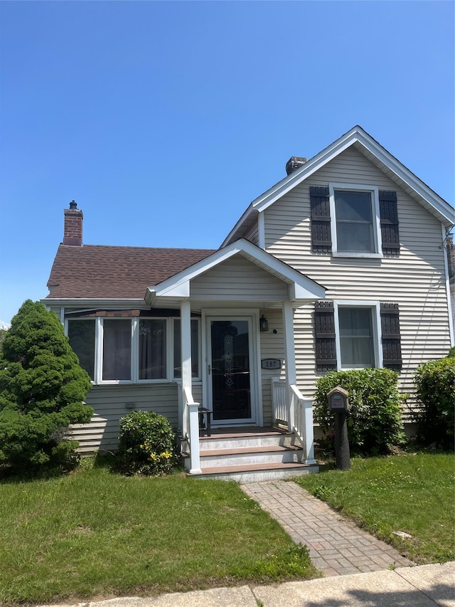 187 Smith Ave, Islip, NY 11751 - bungalow-style home with a chimney and a front lawn