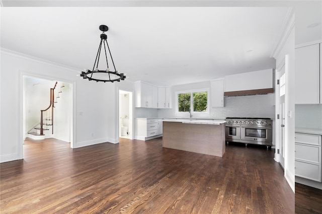 45 Fenimore Rd, New Rochelle, NY 10804 - kitchen featuring double oven range, light countertops, ornamental molding, a kitchen island, and backsplash