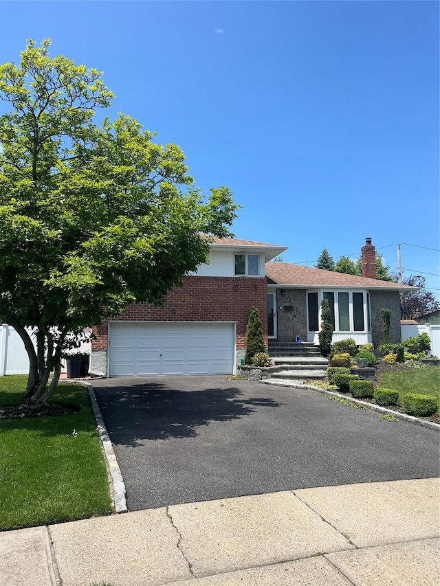 9 Bart Ct, Plainview, NY 11803 - split level home featuring brick siding, driveway, an attached garage, and a chimney