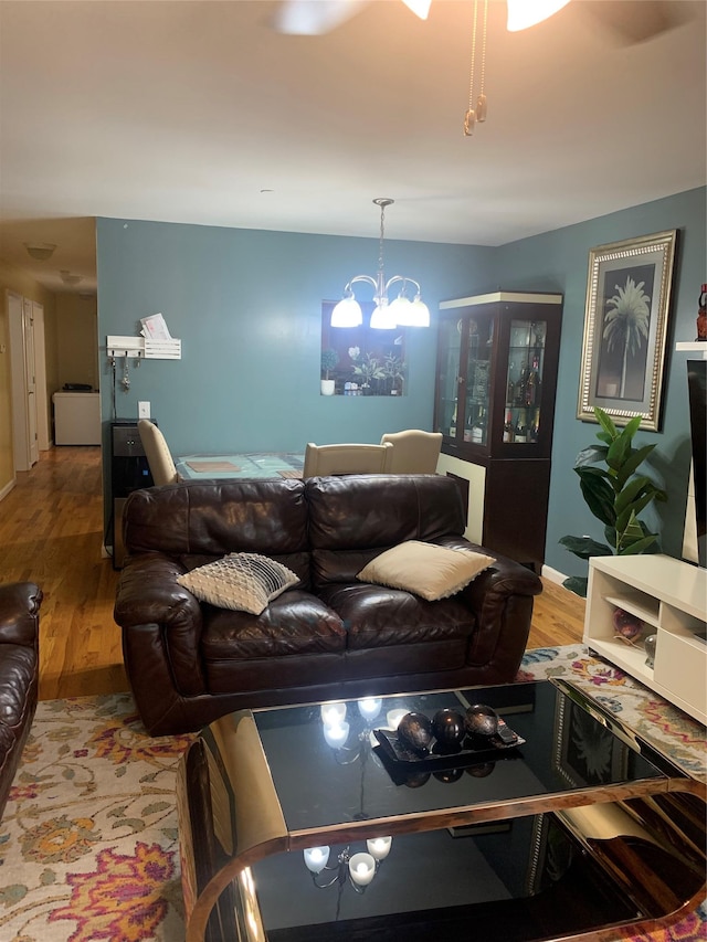 304 Warburton Ave Unit 3A, Yonkers, NY 10701 - living area featuring wood finished floors, a chandelier, and baseboards