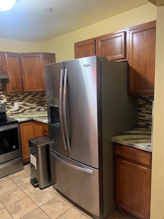304 Warburton Ave Unit 3A, Yonkers, NY 10701 - kitchen with stainless steel appliances, tasteful backsplash, light tile patterned floors, and under cabinet range hood