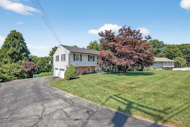 57 Panorama Dr, Patterson, NY 12563 - view of front of property with a garage, a front yard, asphalt driveway, and brick siding