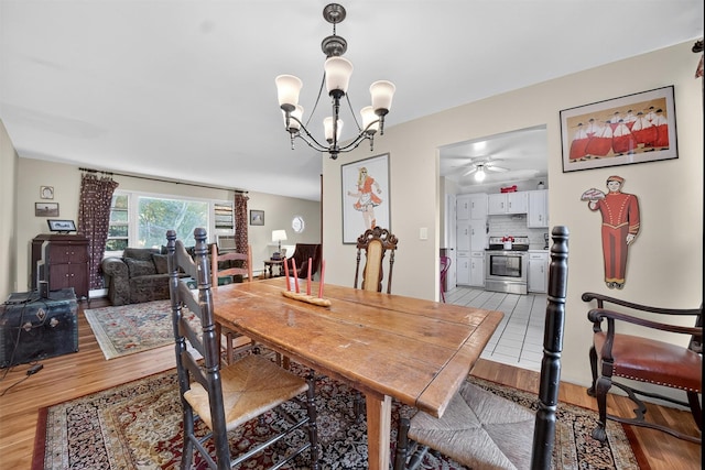 57 Panorama Dr, Patterson, NY 12563 - dining room featuring light wood-style flooring, a chandelier, and ceiling fan