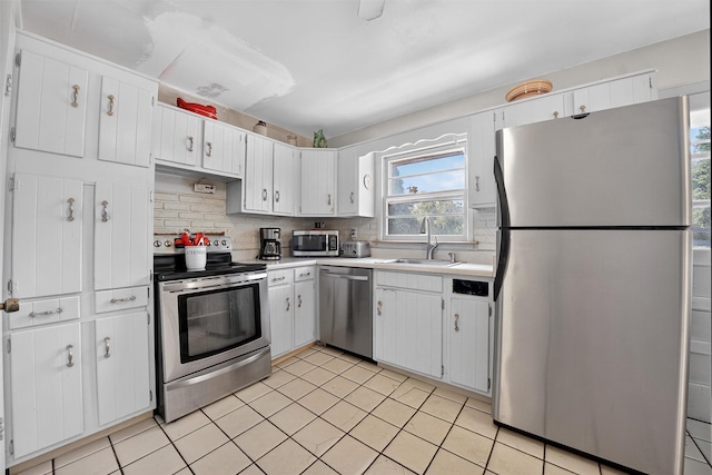 57 Panorama Dr, Patterson, NY 12563 - kitchen featuring stainless steel appliances, light countertops, tasteful backsplash, and white cabinetry