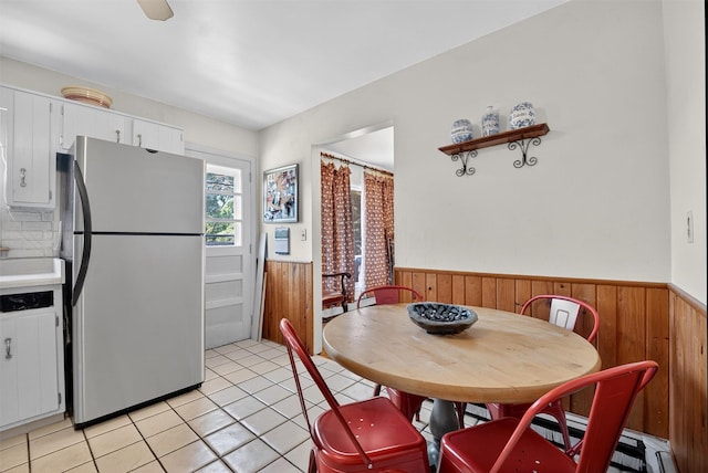 57 Panorama Dr, Patterson, NY 12563 - dining space featuring wainscoting, wooden walls, and light tile patterned flooring