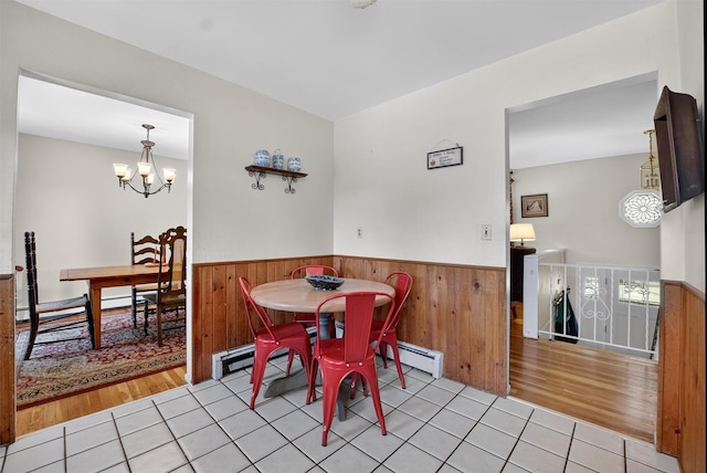 57 Panorama Dr, Patterson, NY 12563 - tiled dining area featuring wainscoting, a chandelier, wooden walls, and baseboard heating