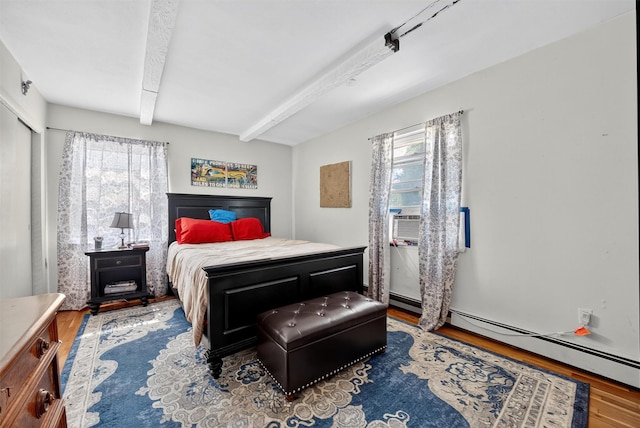57 Panorama Dr, Patterson, NY 12563 - bedroom featuring multiple windows, wood finished floors, beam ceiling, and a baseboard heating unit